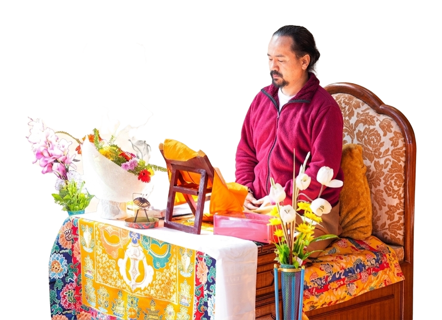 Chogyal Rinpoche sitting inside with flowers
